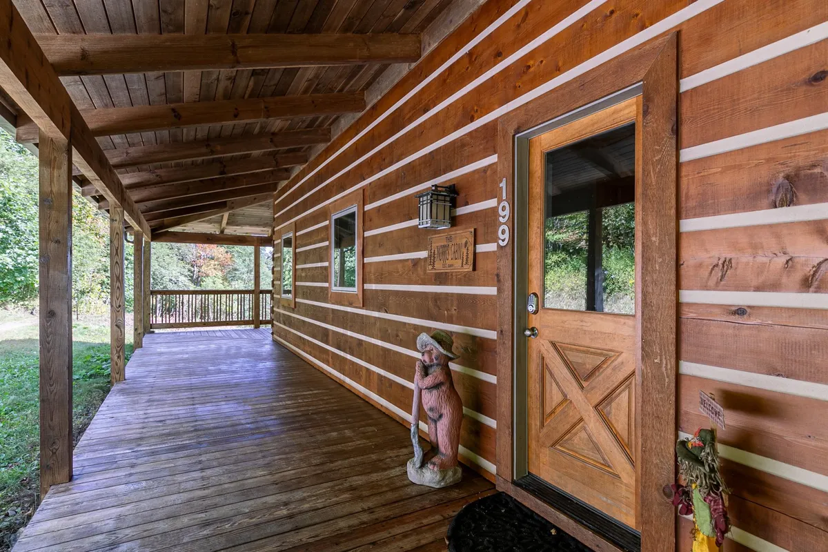 This image features the inviting wooden porch of Morris Cabin, complete with a front door and a decorative statue. The setting communicates a strong connection to the outdoors and hints at the welcoming atmosphere awaiting groups upon arrival. The natural surroundings hint at the area’s scenic beauty and opportunities for relaxation or socializing outside.